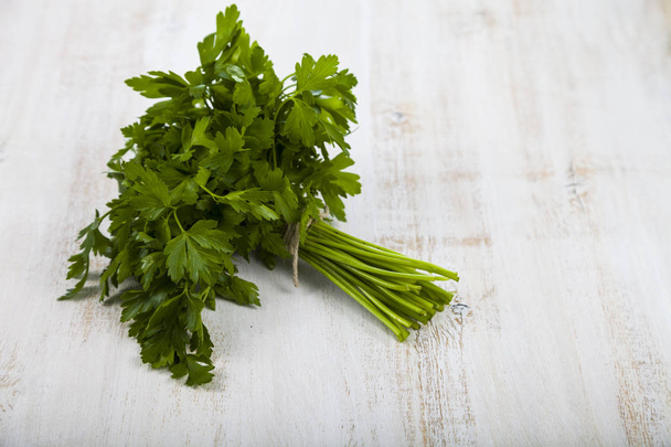 Fresh parsley on a light wooden background. - 写真・画像