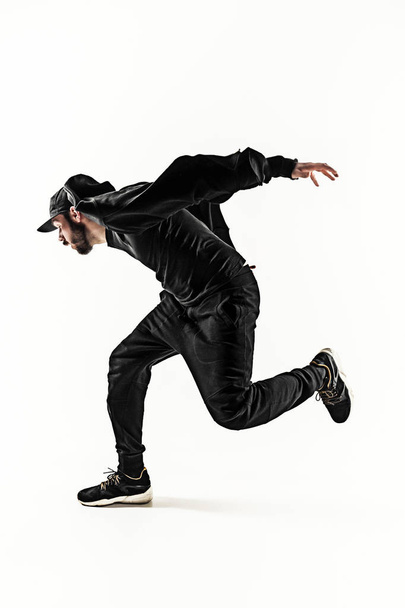 The silhouette of one hip hop male break dancer dancing on white background - 写真・画像