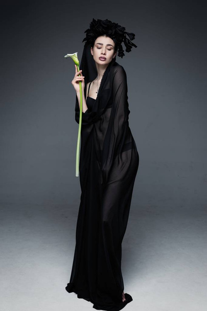 woman veiled by sheer black fabric - Zdjęcie, obraz
