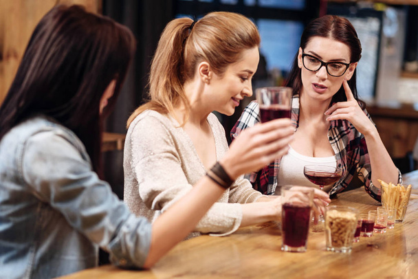 Company of three women spending evening in pub - Zdjęcie, obraz