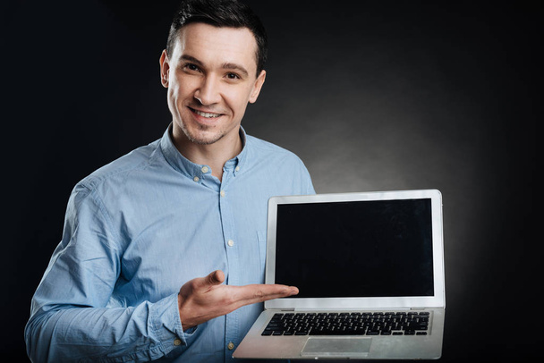 Attractive male presenting his laptop - Photo, image