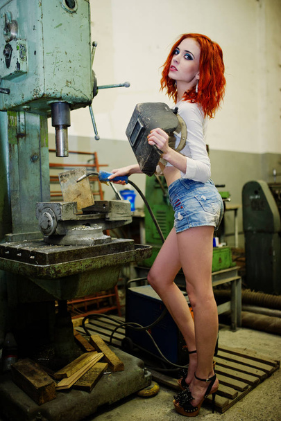 Red haired girl wear on short denim shorts and white blouse with - Foto, afbeelding
