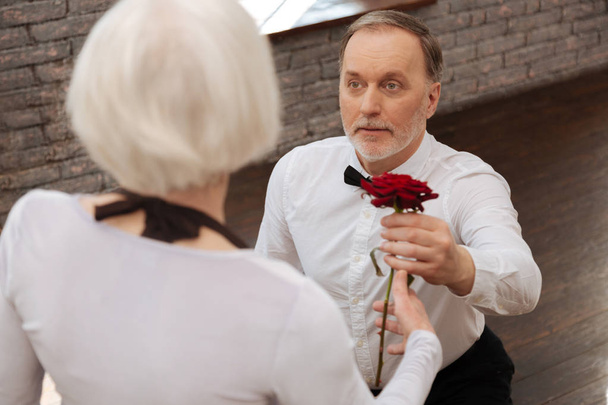 Confident old pensioner expressing love to woman in the ballroom - Φωτογραφία, εικόνα