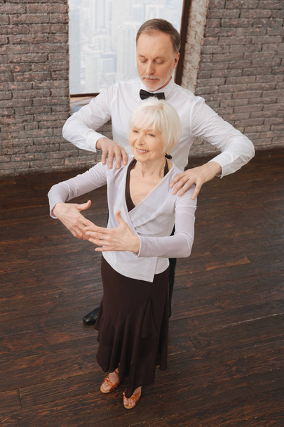 Supportive retired couple performing in the dance studio - Foto, Imagem