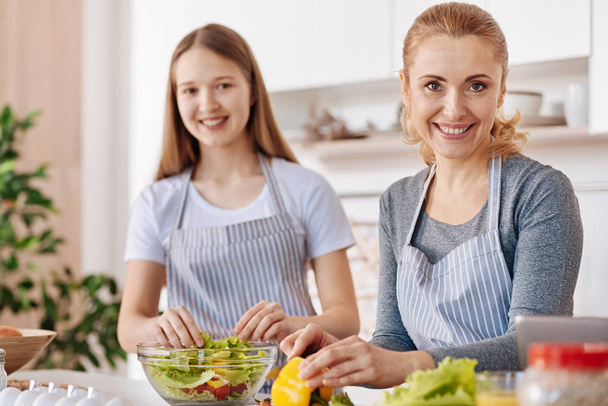 Joyful smiling woman cooking with her daughter - Φωτογραφία, εικόνα