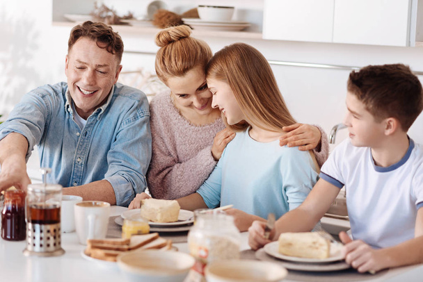 Positive family enjoying their breakfast - Foto, imagen