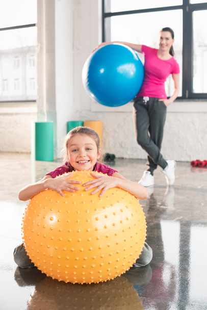 Mother and daughter with fitness balls  - Fotó, kép