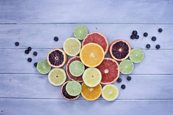 Variety of Citrus Fruits and Blueberries - Foto, afbeelding