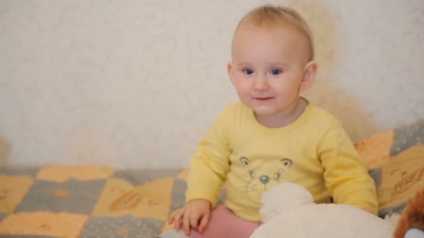Adorable 1-year baby playing with teddy bear - Felvétel, videó