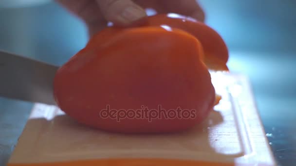 Hand cutting pepper in a kitchen - Footage, Video