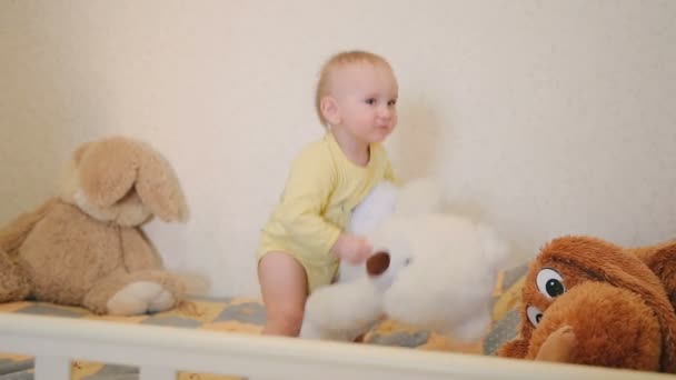 Funny baby playing with teddy bear and posing to camera - Footage, Video