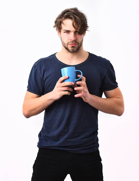 Caucasian sexy young macho holding coffee cup or mug - Fotó, kép