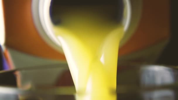 Orange juice is pouring out of the box, slow motion - Footage, Video