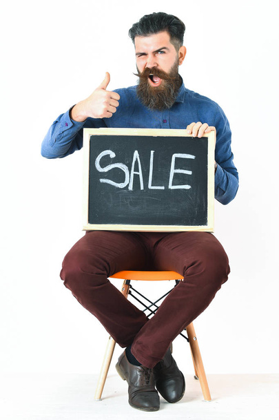 Bearded man, brutal caucasian hipster with moustache holding sale inscription - Foto, Bild