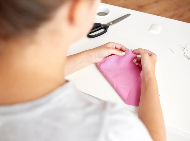 woman with needle stitching fabric pieces - Fotografie, Obrázek