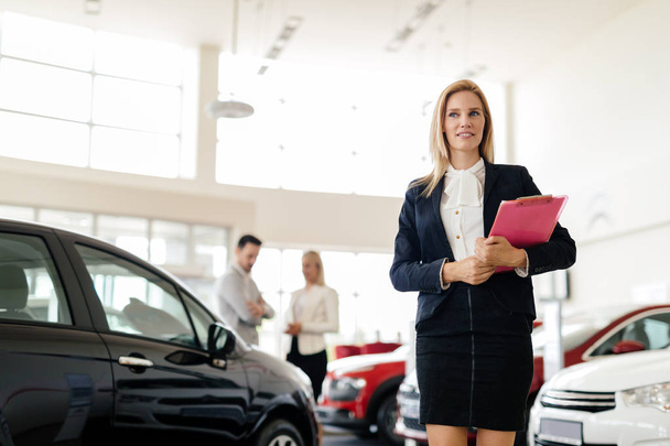 woman selling cars at dealership - Photo, Image