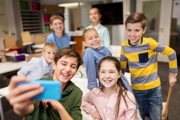group of school kids taking selfie with smartphone - Фото, зображення