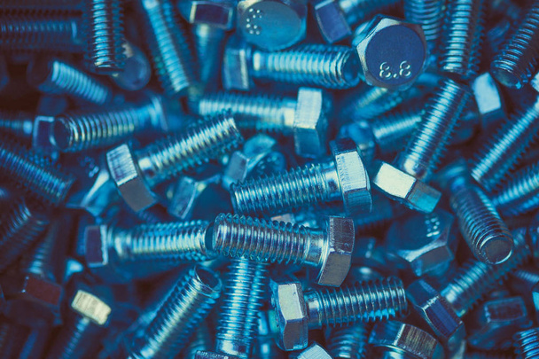 New shiny metal bolts in the heap - Фото, изображение