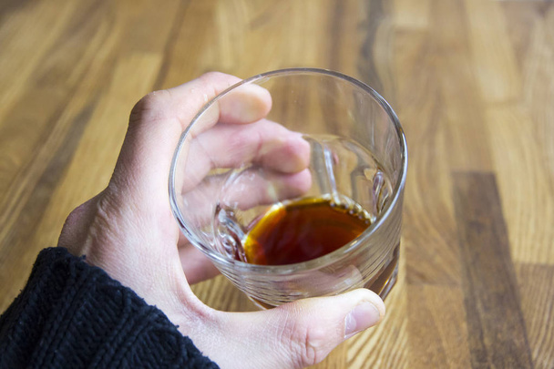 Man's hand hold glass with alcohol - Photo, Image