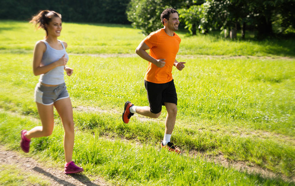 Happy couple running together - Фото, зображення