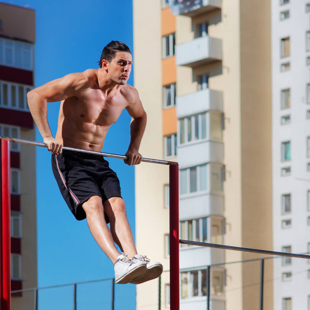 Workout, sportsman pull ups the horizontal bar with big effort - Фото, зображення