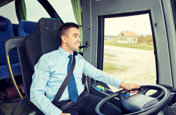 happy driver talking to microphone and driving bus - Fotografie, Obrázek