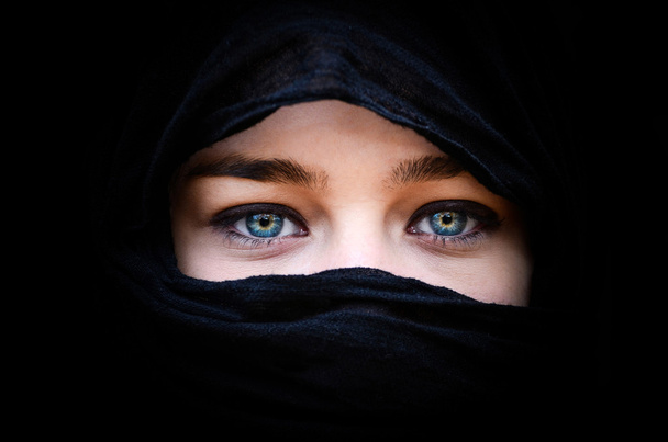 Portrait of beautiful woman with blue eyes wearing black scarf - Фото, зображення
