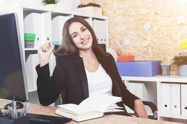 Cheerful manager at her workplace - Foto, imagen