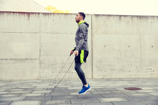 man exercising with jump-rope outdoors - Photo, Image