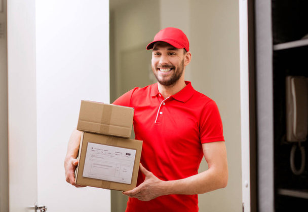 delivery man with parcel boxes at customer door - Fotografie, Obrázek