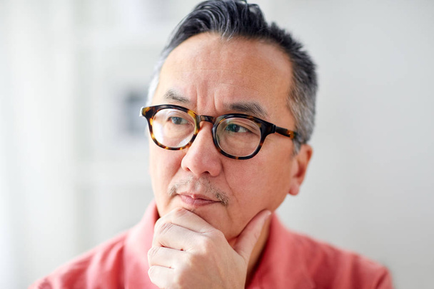 close up of asian man thinking at home - Foto, imagen