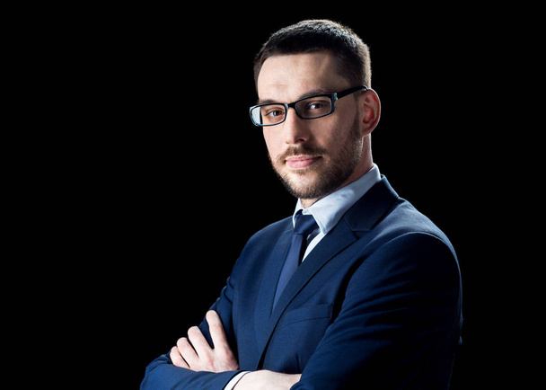 businessman in glasses over black - Foto, Bild