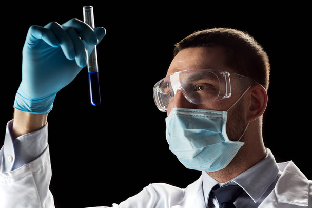 scientist with safety glasses, mask and test tube - Photo, image
