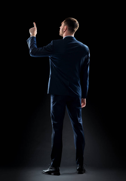 businessman in suit touching something invisible - Foto, Imagem