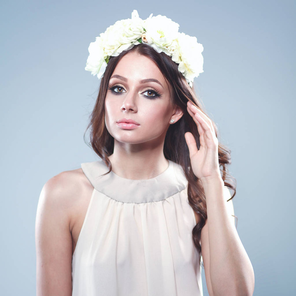 Portrait of a beautiful woman with flowers in her hair. Fashion - Valokuva, kuva