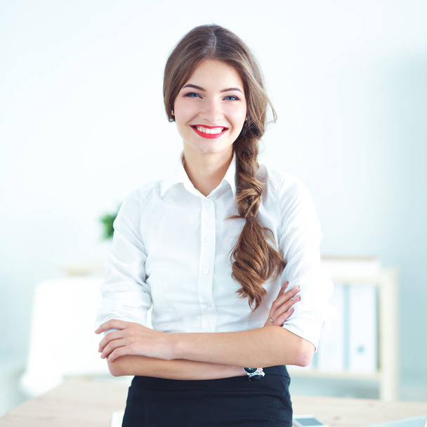 Attractive businesswoman with her arms crossed  standing in office - Фото, зображення