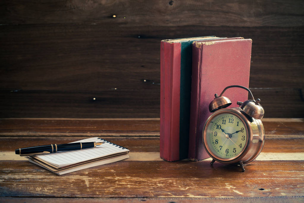 still life alarm clock on old book - Фото, изображение