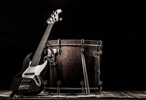 musical instruments, drum bass Bochka bass guitar on a black background - Photo, Image