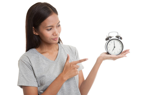 Young Asian woman point to a clock. - Foto, Imagen