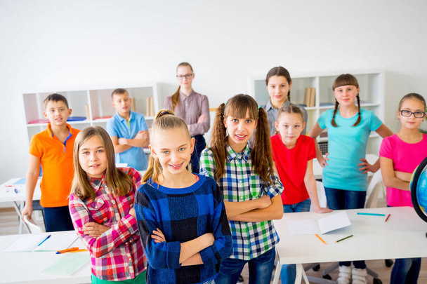 Happy students in classroom - Valokuva, kuva