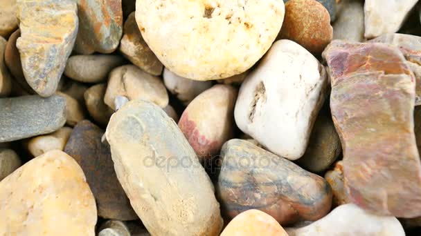 Old stony pavement from natural gravel, dry rounded stones, Traditional building materials, small colorful pebbles. Camera moving close up to ground.  - Footage, Video