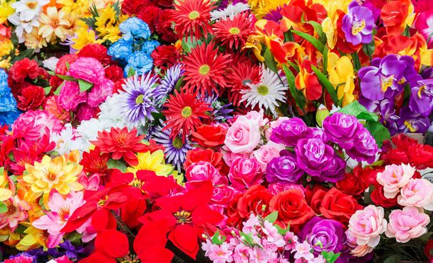 A variety of artificial flowers. Colorful background of flowers - Fotografie, Obrázek