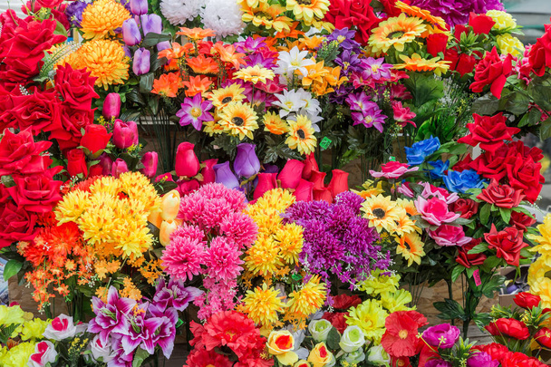 A variety of artificial flowers. Colorful background of flowers - Foto, immagini