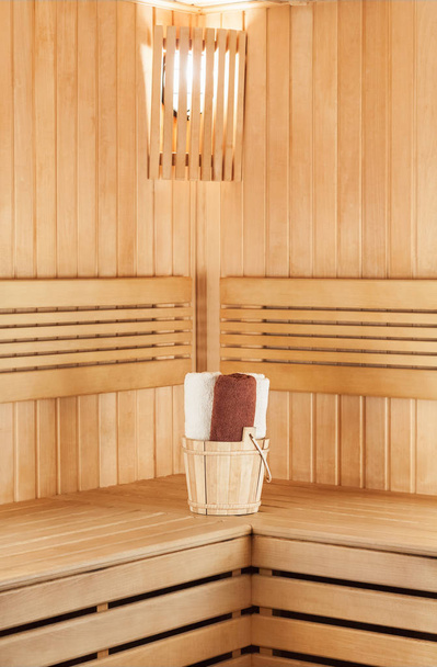 Traditional wooden sauna for relaxation with bucket  - Фото, зображення