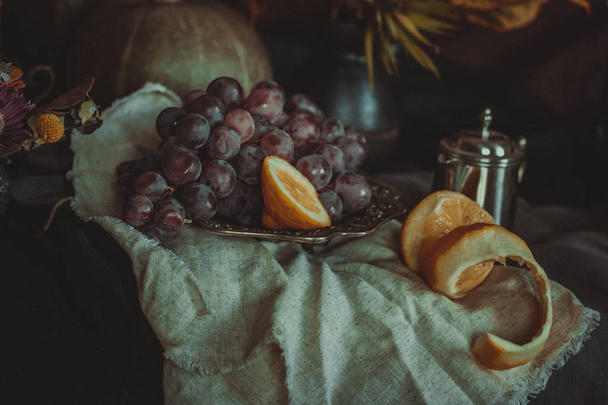 Details of autumn holland still life stylization with grapes and lemon on drapery - Foto, Bild