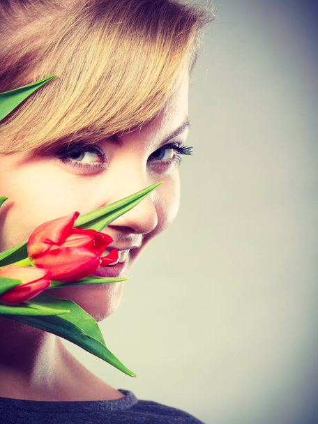 Girl with tulip feel connection to nature. - 写真・画像