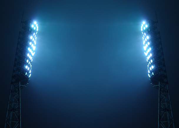 Stadionin valonheittimet pimeää yötaivasta vastaan
 - Valokuva, kuva