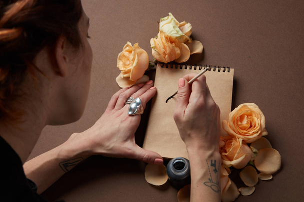 woman writing in craft notepad - 写真・画像