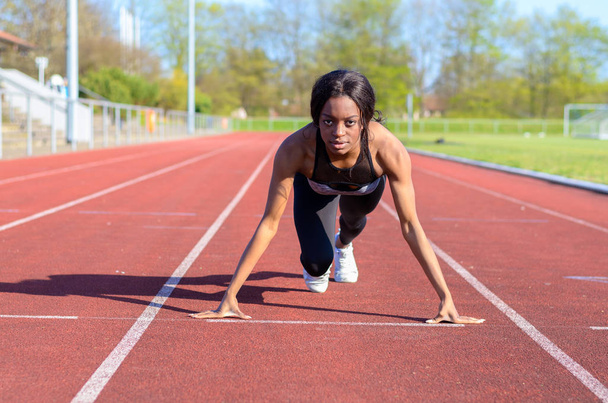 Femme s'entraînant au sprint sur une piste de sport
 - Photo, image
