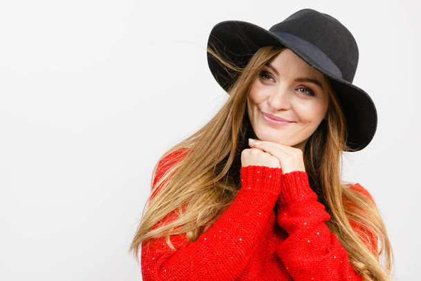 Smiling pretty girl with brown hair and black hat. - 写真・画像